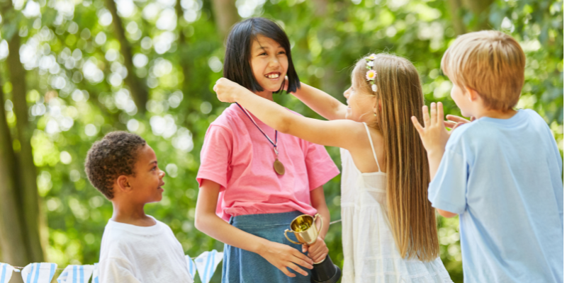 Canvas Photo showing a children placing a medal on one child, pulled for American Awards of Augusta Maine website.